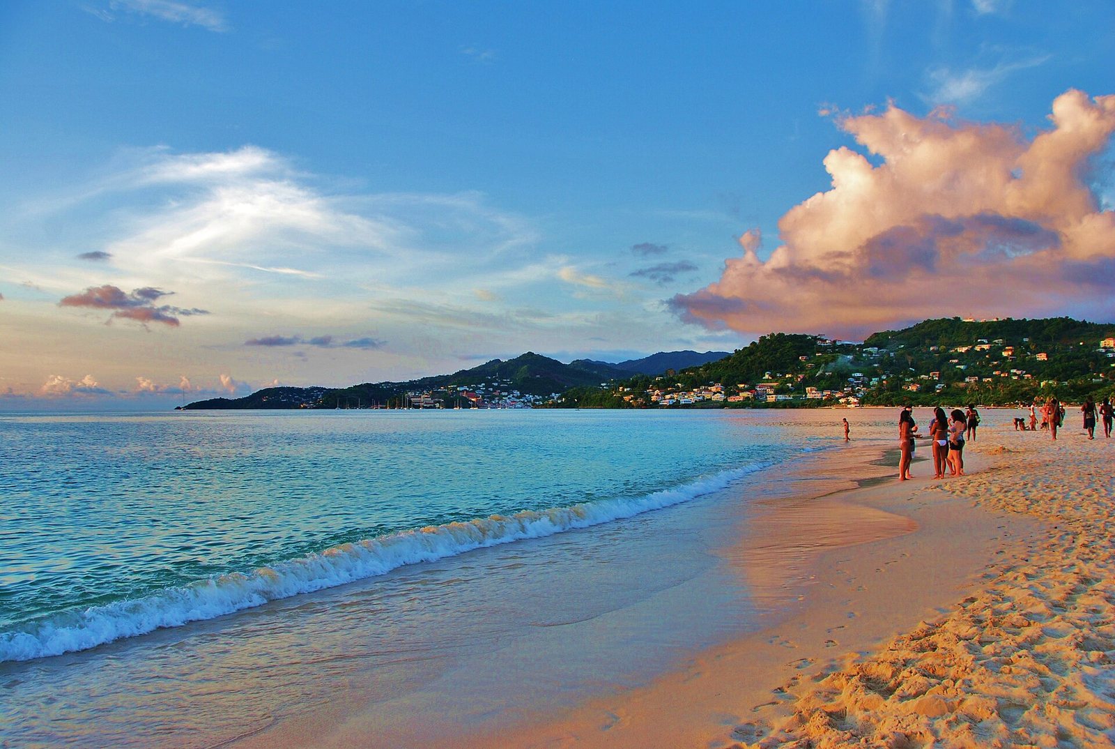 The long sweep of Grand Anse Beach, Grenada, almost empty, with St. George's visible across the bay