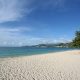 A wide stretch of white sand and calm turquoise water at Grand Anse beach, Grenada