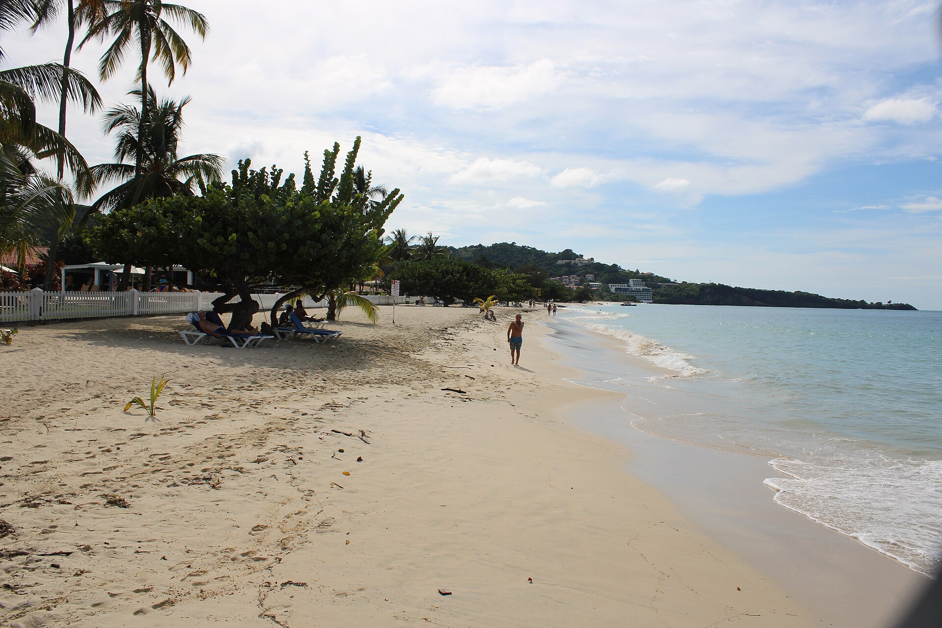 The long sweep of Grand Anse Beach in Grenada with calm turquoise water
