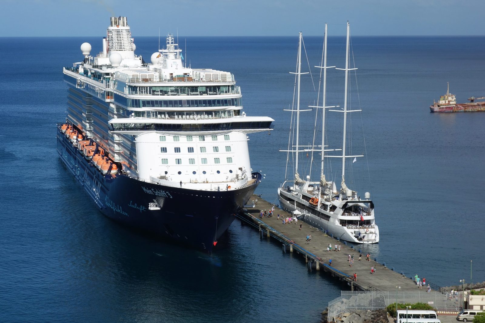 Cruise ships moored at the Grenada cruise pier at St. George's, with passengers walking along the quay