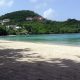 The crescent bay at Morne Rouge, Grenada, with flat turquoise water and empty white sand